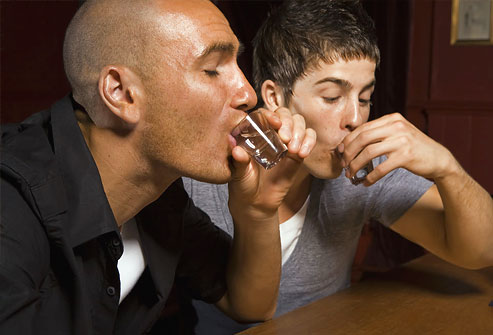 men_doing_shots_at_bar